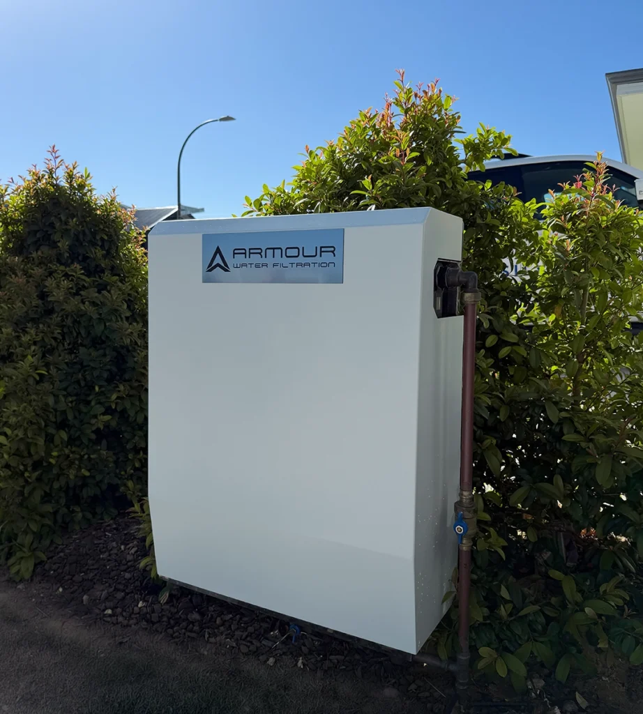 Whole home water filtration system installed outdoors to reduce heavy metals and improve water quality for safer household use.