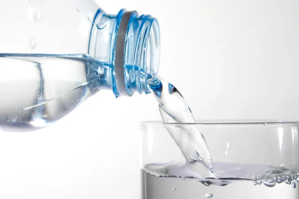 Pouring clean drinking water into a glass, representing Melbourne water quality and safe, clear tap water for everyday use.